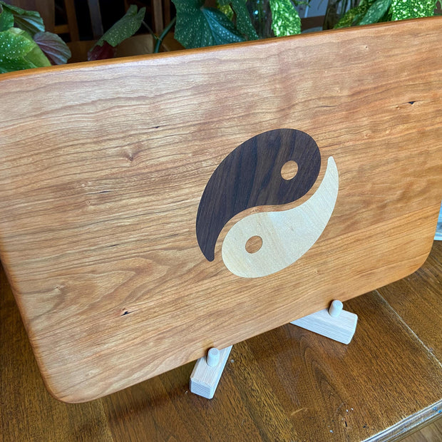 Cherry charcuterie board with Yin Yang inlay made from Peruvian Walnut and Maple.